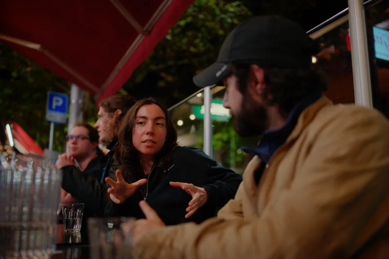 Gallery image: 03 pizza 08 talking over drinks outside.webp